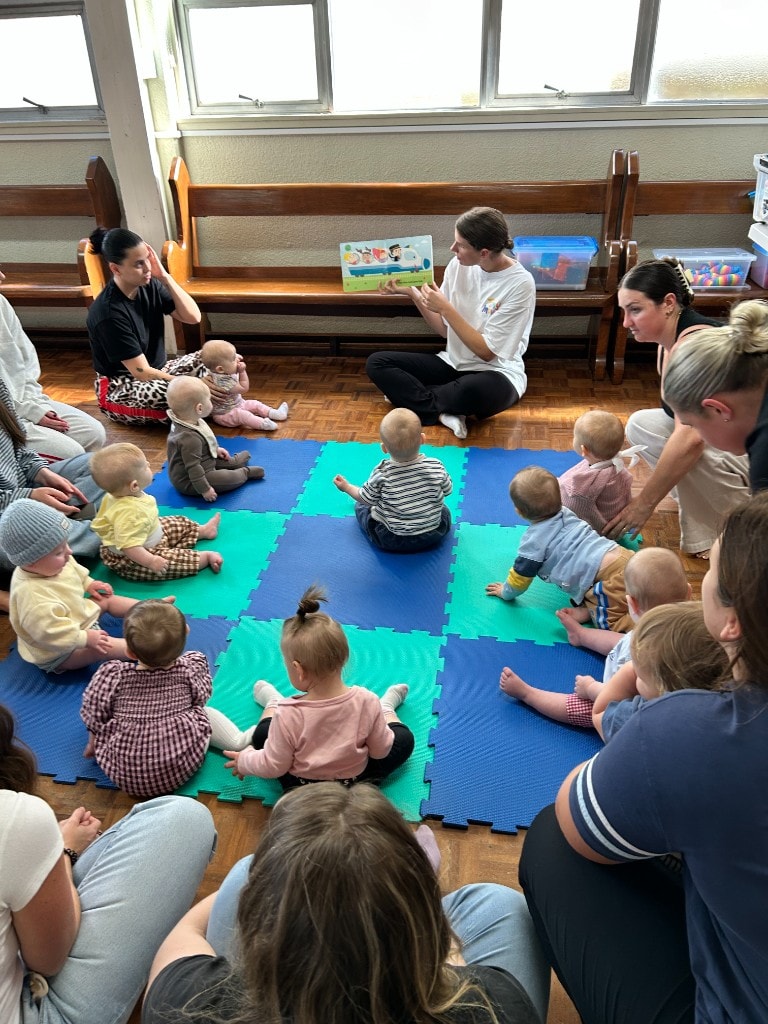 Anna reading to babies and toddlers in a Tiny Moves class