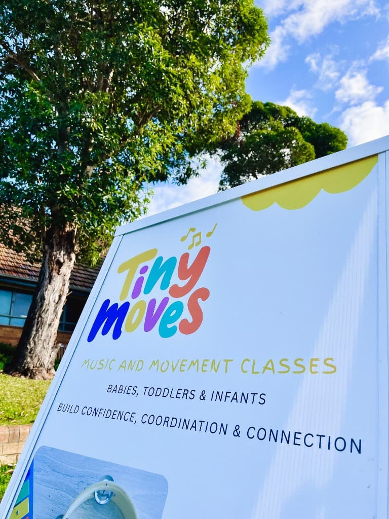 Tiny Moves outdoor A-frame sign promoting music and movement classes for babies, toddlers and infants